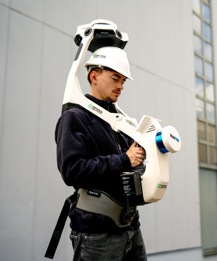 Surveyor wearing a backpack mobile mapping system and a hard hat